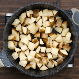 Pan with diced potatoes in oil ready for frying.