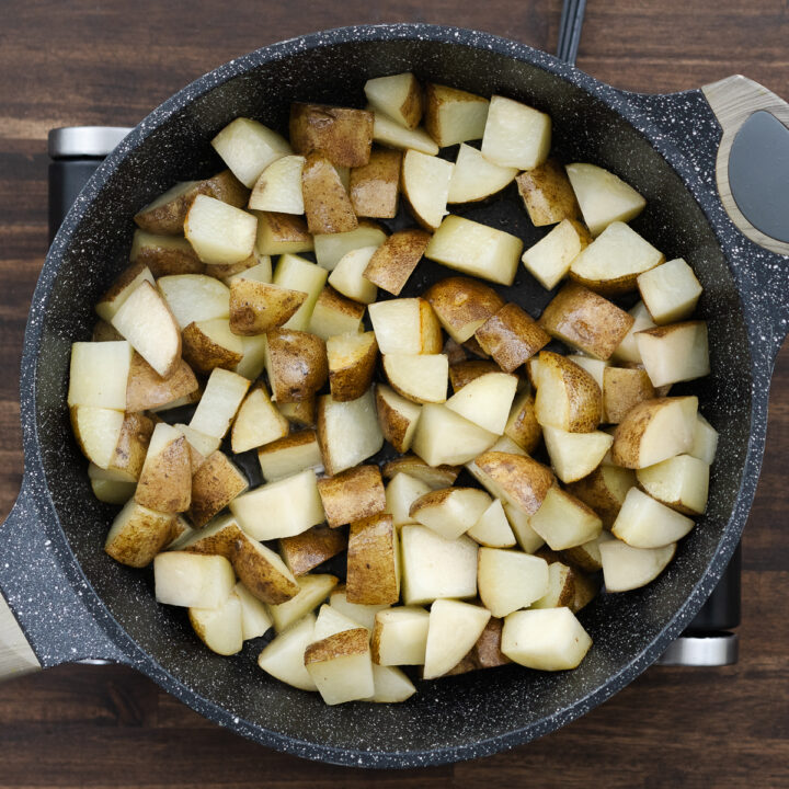 Pan with nicely crisped up diced potatoes.