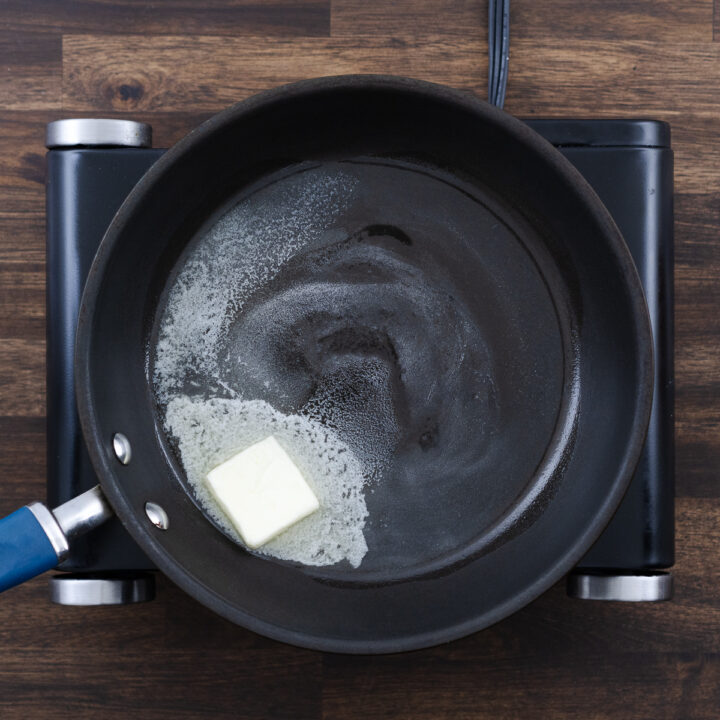 Butter melting in a pan over medium heat.